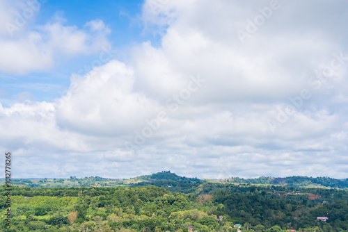 a lush, green landscape under a partly cloudy sky