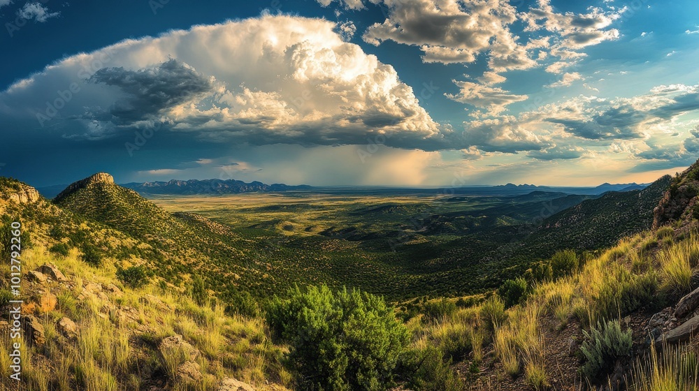 Expansive Mountain Landscape with Dramatic Clouds and a Rain Shower in the Distance Expansive Mountain Landscape with Dramatic Clouds and a Rain Shower in the Distance