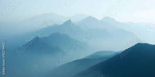 A mountain range veiled in fog, with only the highest peaks visible, creating a mystical and serene landscape that invites exploration and adventure.