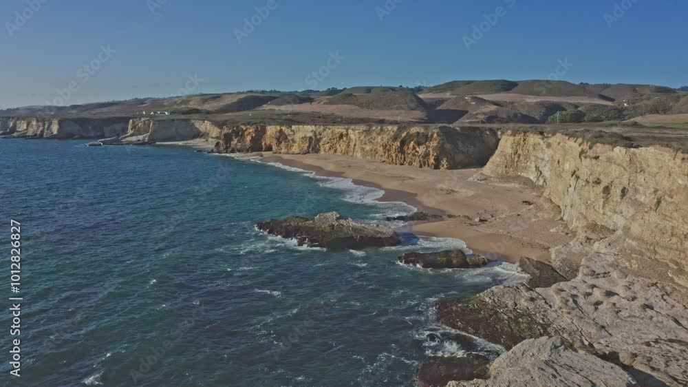 Aerial view of beautiful sandy beach and cliffs of Pacific Ocean coast on Highway 1 in California, Davenport, Santa Cruz. 4K shooting. Travel concept, tourism, recreation, vacation Aerial view of beautiful sandy beach and cliffs of Pacific Ocean coast on Highway 1 in California, Davenport, Santa Cruz. 4K shooting. Travel concept, tourism, recreation, vacation
