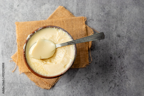 Misti doi is a traditional Bengali sweet yogurt made by caramelizing milk and sugar, known for its creamy, rich flavor. Selective focus. photo