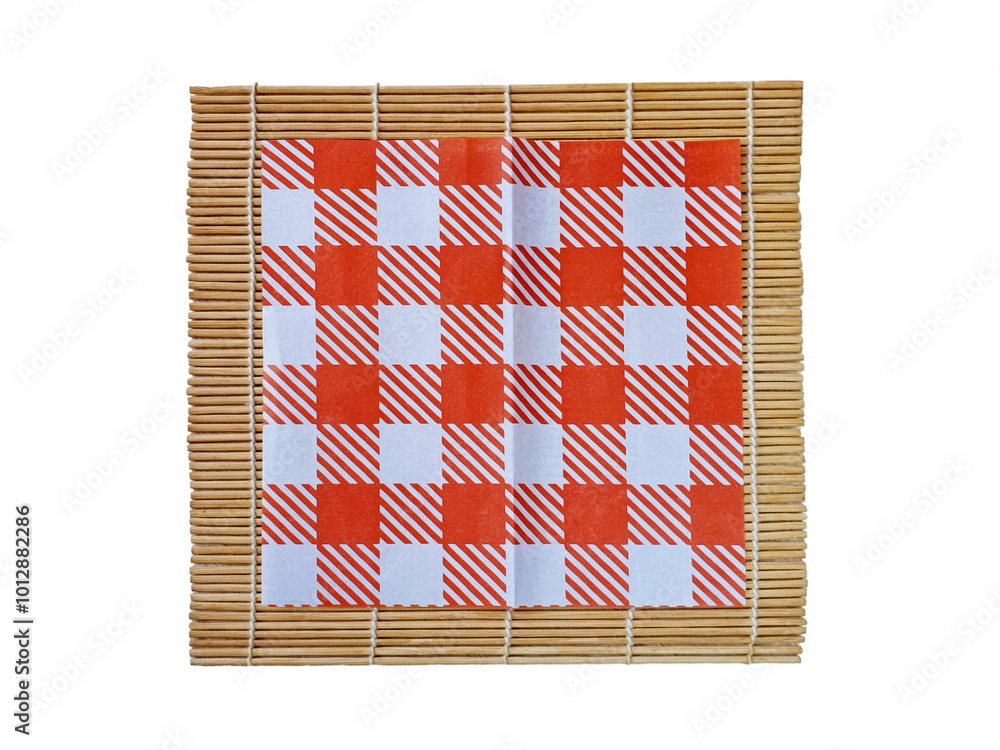Checkered red and white paper napkin on bamboo mat isolated on white background with clipping path. Japanese style template. Top view of cooking composition with empty place. Food mockup flat lay. Checkered red and white paper napkin on bamboo mat isolated on white background with clipping path. Japanese style template. Top view of cooking composition with empty place. Food mockup flat lay.