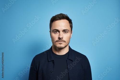 Portrait of a young man on a blue background. Studio shot.