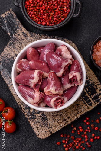 Raw chicken hearts with salt, spices and herbs