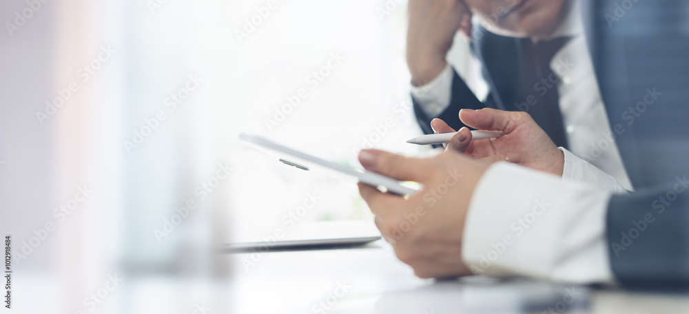 Fototapeta premium Close up of business team using digital tablet, havie a discussion on business data, accountancy document at office. teamwork and partnership co-working, business solution concept.