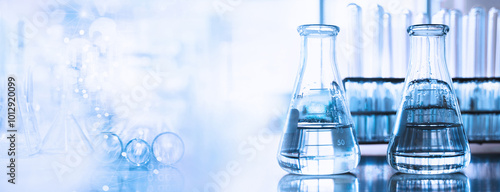 flask and test tune in science research lab with blue banner background