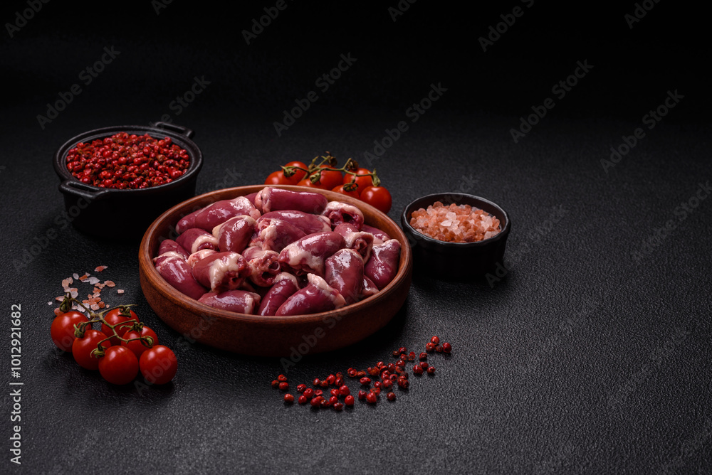 Raw chicken hearts with salt, spices and herbs Raw chicken hearts with salt, spices and herbs