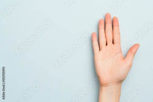 Open hand gesture against a light blue background, symbolizing welcome or greeting.