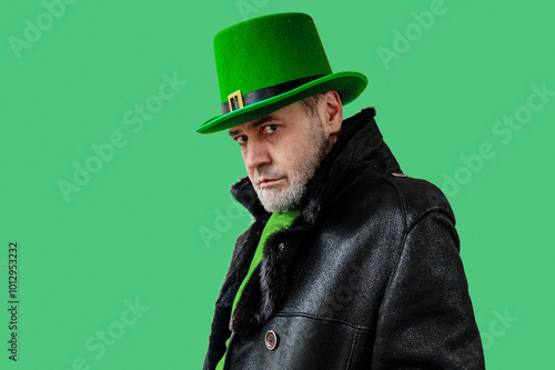 St. Patrick's Day. Handsome man wearing green hat. Green background