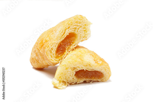 A golden-yellow pastry filled with sweet yellow pineapple jam, offering a deliciously sweet taste. Photographed on a white background.