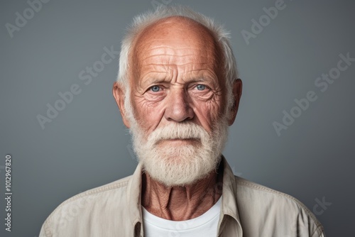 Portrait of an old man with white beard and mustache. Isolated on grey background.