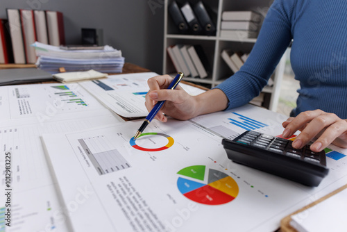 Business financing accounting banking concept. Business woman hand doing finances and calculate on desk about cost at home office. Woman working on desk with using calculator, finance accounting. 