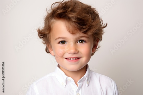 Portrait of a cute little boy in a white shirt. Studio shot.