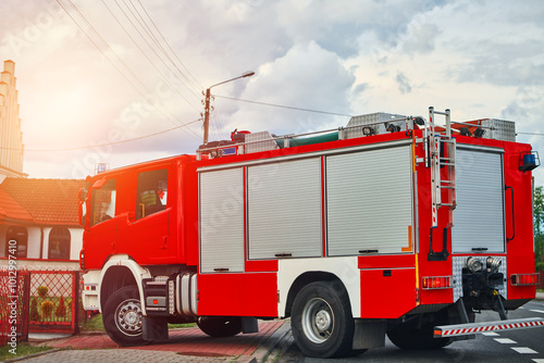 Fire engine cruising down the street in suburban town. photo