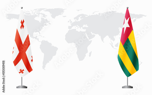 Georgia and Togo flags for official meeting against background of world map.