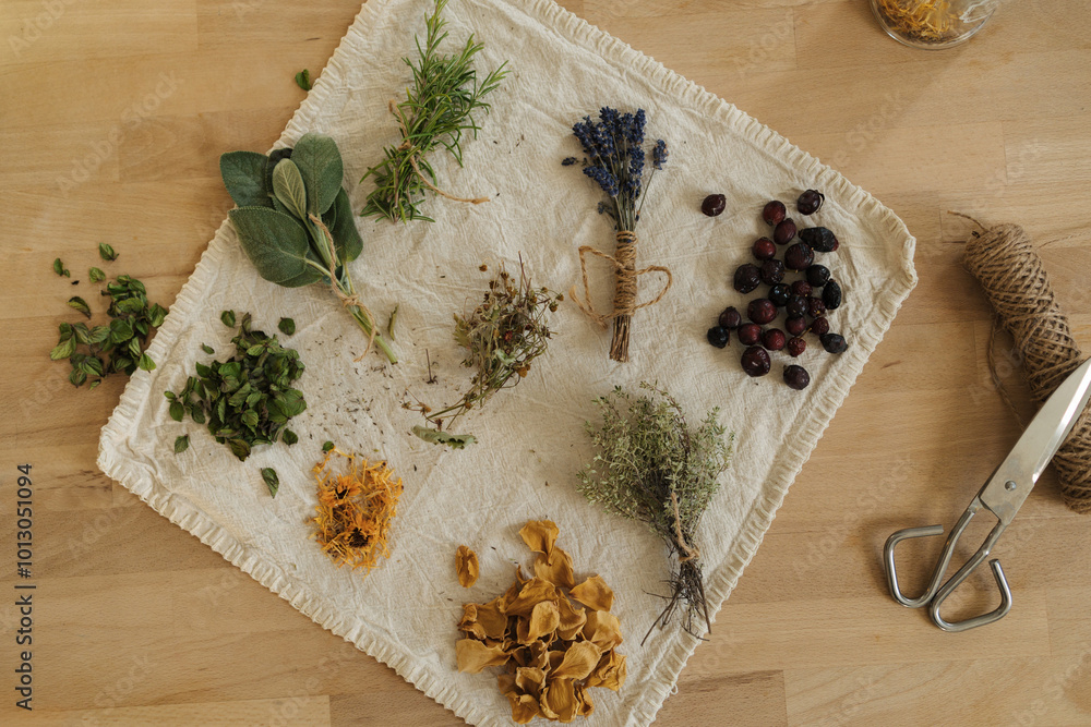 Top view of different dried herbs on linen tablecloth. Wooden table scissors, natural twine. Top view of different dried herbs on linen tablecloth. Wooden table scissors, natural twine.