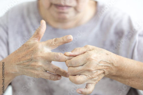 Senior woman with Trigger finger disease,pain in hand,elderly massaging,rubbing and kneading of muscles and joints,stretch the tendons in fingers,exercise her hand,therapy,health care,medical concept photo