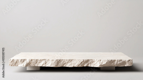 Rough Stone Slab Pedestal on Light Grey Background. Minimalist Platform for Product Display and Natural Design Concepts.