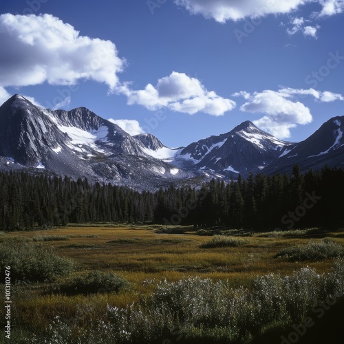 Snow-Capped Mountains Towering Over Tranquil Landscape