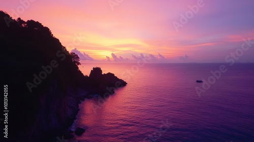 A stunning sunset view from a cliff on Koh Tarutao, with vibrant colors reflecting off the water and creating a magical scene.