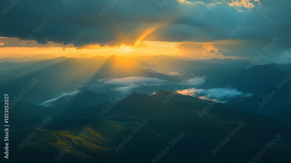 The sun shines through the clouds, casting rays of light on mountains and green grass in mountainous areas The sun shines through the clouds, casting rays of light on mountains and green grass in mountainous areas