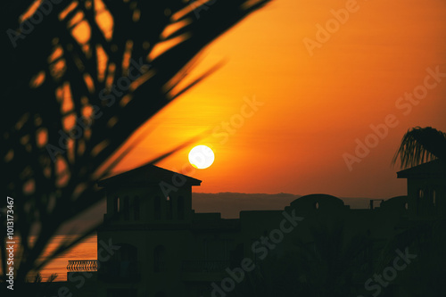 Close-up of beach umbrellas - beautiful setting sun in the background. Beach on the Red Sea, Egypt