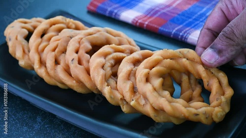 Serving kai murukku Indian snack in a plate. photo