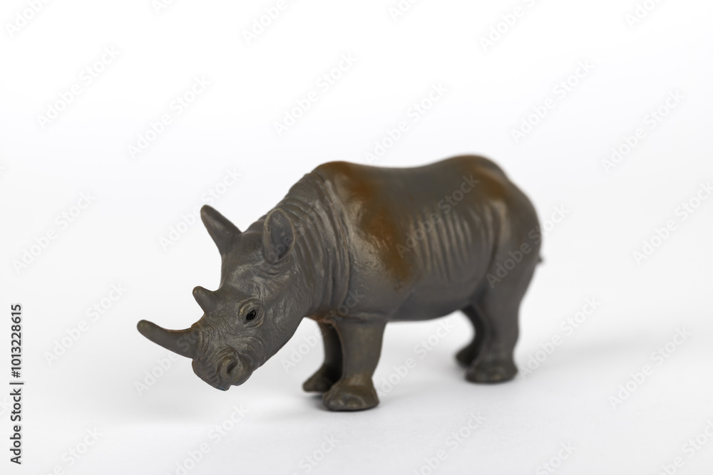 Fototapeta premium Grey plastic toy rhinoceros isolated on white background. Concept of mammal animals
