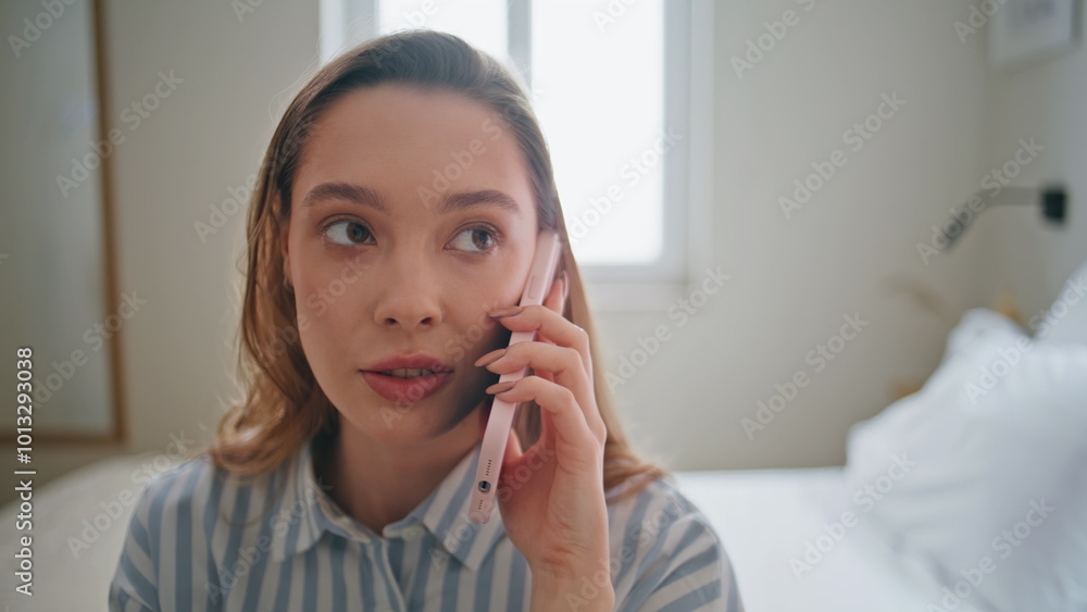 Portrait girl speaking cellphone sitting comfortable white bed. Woman calling Portrait girl speaking cellphone sitting comfortable white bed. Woman calling