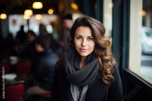 Portrait of a beautiful young woman in a cafe on a winter day