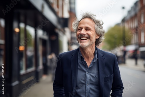 Portrait of happy senior businessman laughing outdoors. Mature man in formalwear looking at camera.