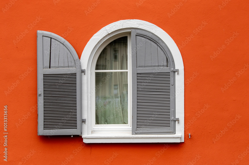 Fototapeta premium White and grey round window over orange wall