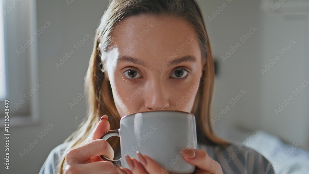 Homely woman savoring coffee in bedroom closeup. Relaxed girl drinking beverage Homely woman savoring coffee in bedroom closeup. Relaxed girl drinking beverage