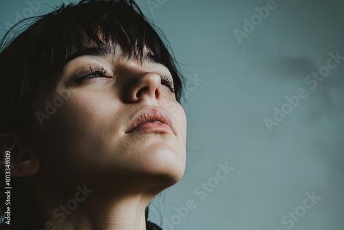 A person sighing deeply while staring off into the distance, showing visible signs of emotional exhaustion and stress, highlighting behavioral cues of stress photo