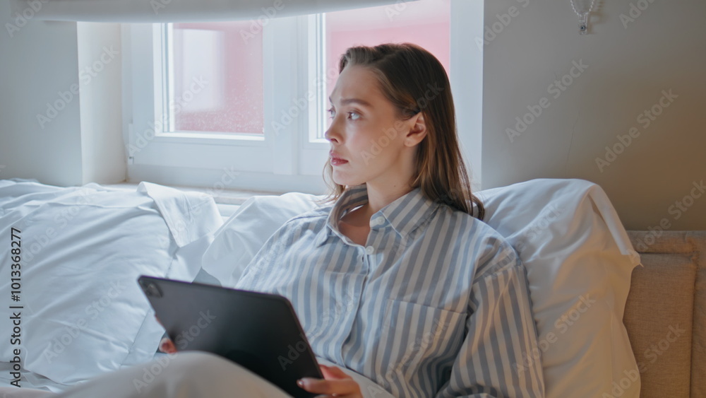 Businesswoman browsing tablet bedroom at morning routine closeup. Serious woman Businesswoman browsing tablet bedroom at morning routine closeup. Serious woman