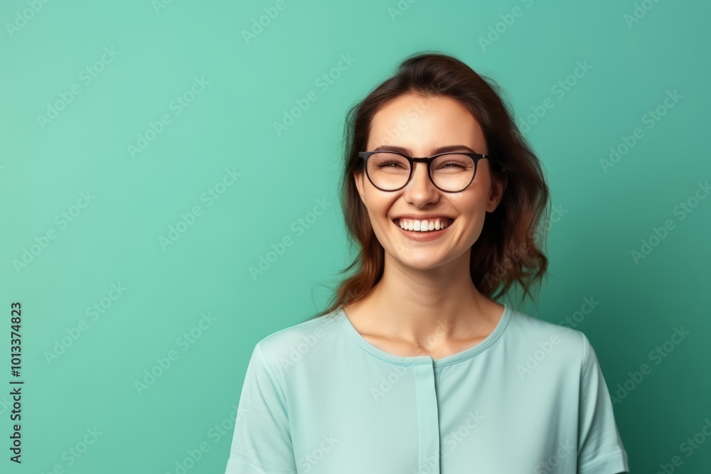 Happy young woman in eyeglasses on a turquoise background Happy young woman in eyeglasses on a turquoise background