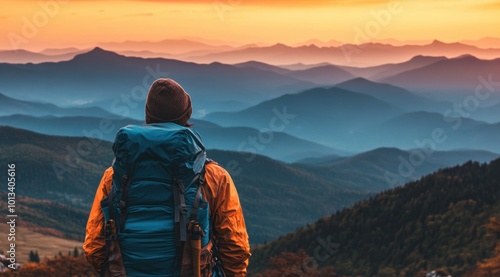 A backpacker on the mountain, with their back to us and wearing hiking gear