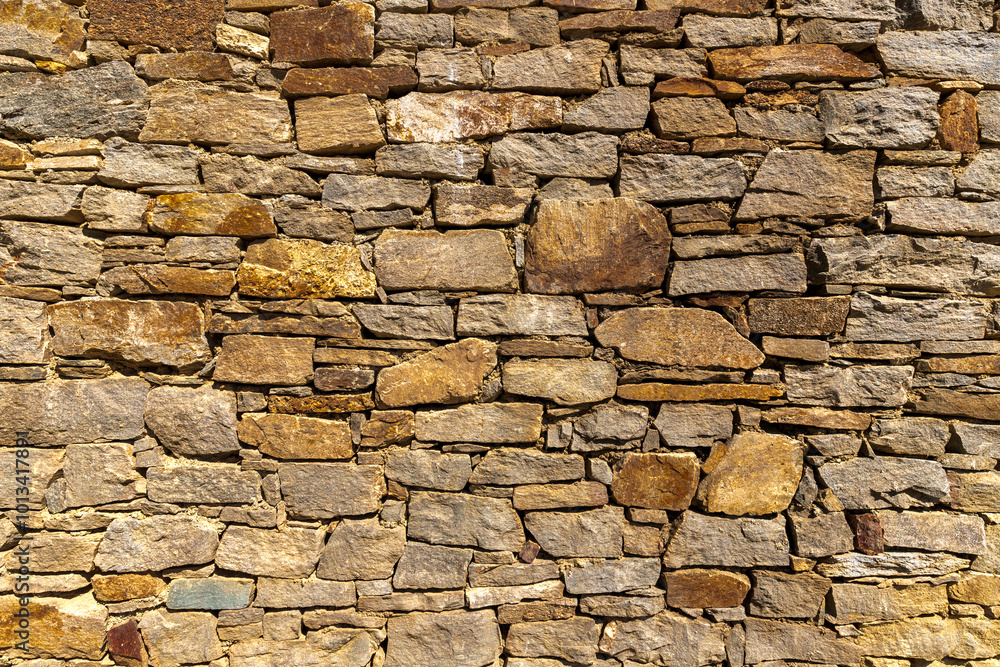 Fototapeta premium The surface of an stone wall, perfect for the background.