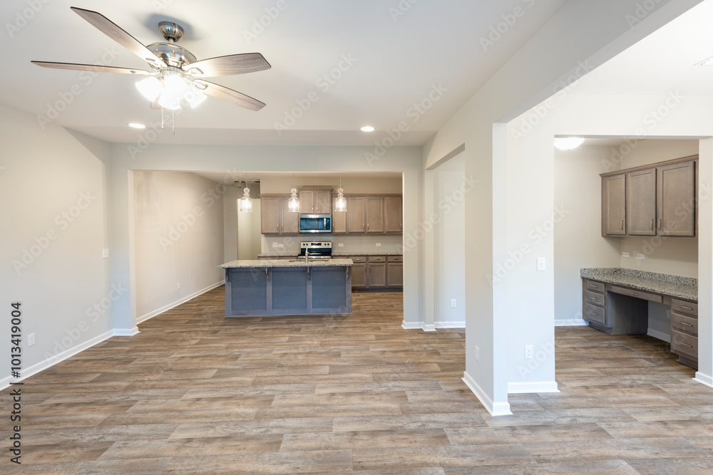 Empty modern townhouse floor showcasing a kitchen, a workspace, living, and dinning room ready to be moved in. Investment, renting, or house ownership concept. Empty modern townhouse floor showcasing a kitchen, a workspace, living, and dinning room ready to be moved in. Investment, renting, or house ownership concept.