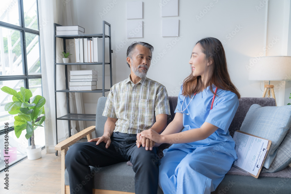 Caring nurse in blue scrubs sits on a couch, holding hands with an elderly man during a home visit, showing compassion and support Caring nurse in blue scrubs sits on a couch, holding hands with an elderly man during a home visit, showing compassion and support
