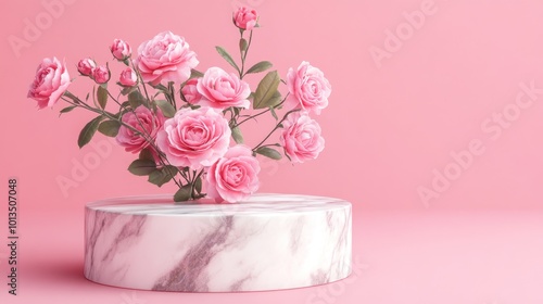 A bouquet of pink roses in a marble vase against a soft pink background.