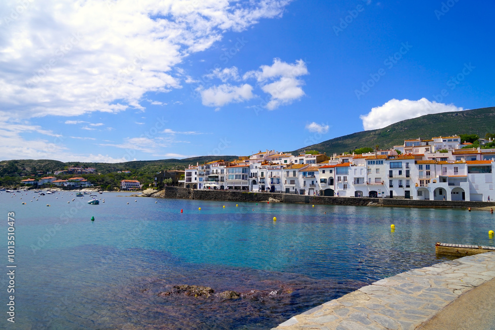 view over the Badia de Cadaqués, to the beautiful white houses of Cadaqués with the turquoise water of the Mediterranean Sea, mountains of the Pyrenees behind, Girona, Catalonia, Spain view over the Badia de Cadaqués, to the beautiful white houses of Cadaqués with the turquoise water of the Mediterranean Sea, mountains of the Pyrenees behind, Girona, Catalonia, Spain