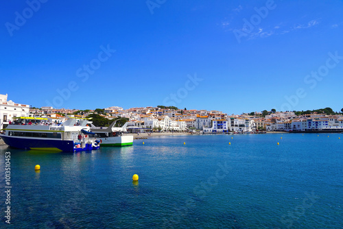 view over the Badia de Cadaqués, to the beautiful white houses of Cadaqués, Port Alguer and the turquoise water of the Mediterranean Sea, mountains of the Pyrenees behind, Girona, Catalonia, Spain