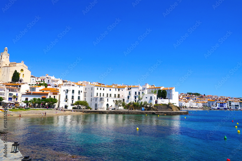 Fototapeta premium Santa Maria de Cadaqués church and white houses of the beautiful village Cadaqués at the Port Alguer, Girona, Catalonia, Spain