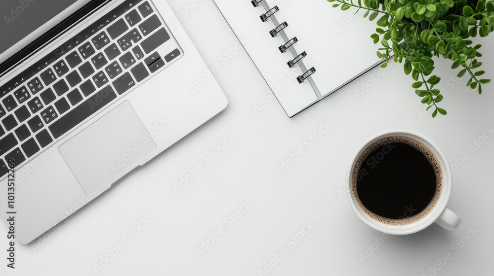 A workspace featuring a laptop, notebook, coffee cup, and a small plant. A workspace featuring a laptop, notebook, coffee cup, and a small plant.