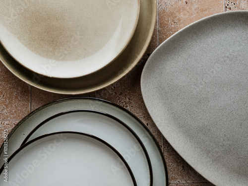 Top view of modern various ceramic plates on a kitchen table, cooking concept.