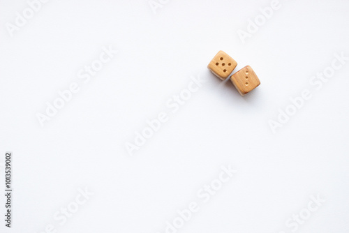 These are photos of wooden dice on a white background. They include shots of aligned, scattered, and stacked dice There are photos of a single die, a pyramid of dice. photo