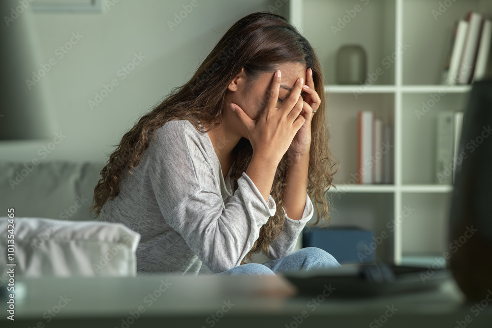 Young Asian woman sitting in a bedroom, feeling sad tired and worried suffering depression in mental health. in concept of depression anxiety and insomnia Young Asian woman sitting in a bedroom, feeling sad tired and worried suffering depression in mental health. in concept of depression anxiety and insomnia