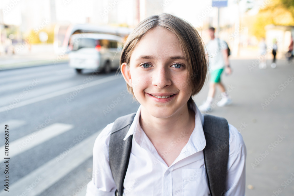 Portrait of smiling 12 year old boy in white shirt with backpack on his way to school. Portrait of smiling 12 year old boy in white shirt with backpack on his way to school.