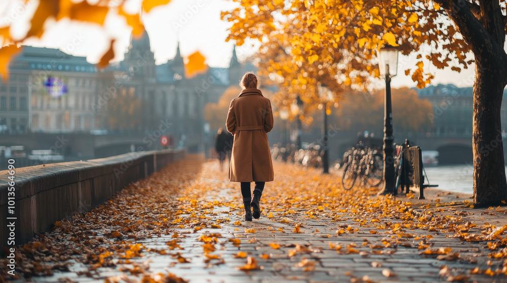 A person walks along picturesque autumn path lined with vibrant orange leaves, showcasing beauty of season. warm sunlight filters through trees, creating serene atmosphere A person walks along picturesque autumn path lined with vibrant orange leaves, showcasing beauty of season. warm sunlight filters through trees, creating serene atmosphere